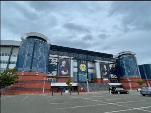 a building with a parking lot in front of it at Regent Apartments - Glasgow City in Glasgow