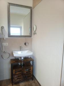 a bathroom with a sink and a mirror at Wohnung Auszeit in Wald