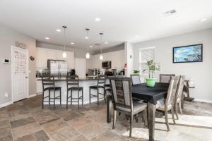 a kitchen and dining room with a table and chairs at Sunny Vegas Oasis Escape in Las Vegas