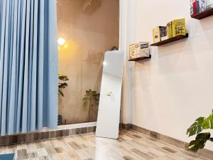 a refrigerator in a room with a window at Nguyên căn Lazánia homestay ở Bình Minh Tây Ninh in Ấp Bình Trung