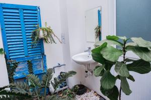 a bathroom with a blue window and a sink at Nguyên căn Lazánia homestay ở Bình Minh Tây Ninh in Ấp Bình Trung +15 photos