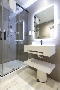 a bathroom with a sink and a shower at Hotel La Milagrosa in Alicante