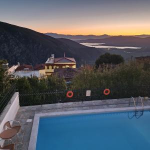 a swimming pool with a view of the mountains at Hotel Apollonia in Delfoi