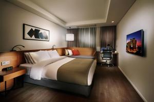 a hotel room with a large bed and a desk at Ramada by Wyndham Gunsan in Gunsan-si