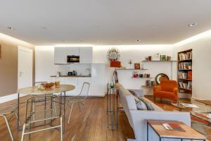 a living room with a couch and a table at Sweet Inn - Amiral de Coligny in Paris