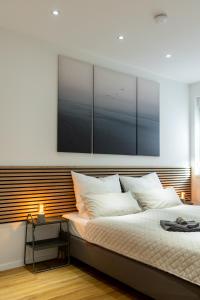 a bedroom with a large bed with white pillows at Ferienwohnung mit Terrasse - Erdgeschoss in Weilburg