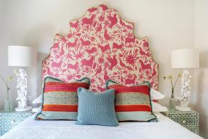 a bedroom with a bed with a pink headboard and pillows at Limani Suite in Longós +17 photos