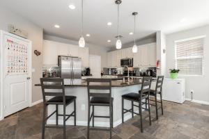 a kitchen with a large island with bar stools at Sunny Vegas Oasis Escape in Las Vegas