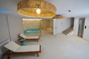 a living room with a swimming pool and a large ceiling at Misk Villa - Boutique Hotel & Spa in Sidi Bou Saïd