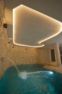 a large swimming pool with a water fountain at Misk Villa - Boutique Hotel & Spa in Sidi Bou Saïd