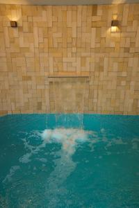 a swimming pool with a fountain in the water at Misk Villa - Boutique Hotel & Spa in Sidi Bou Saïd