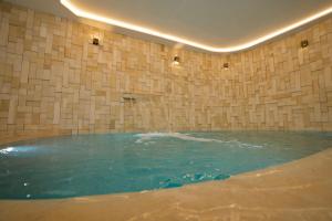 a large pool of water in a room with a tile wall at Misk Villa - Boutique Hotel & Spa in Sidi Bou Saïd