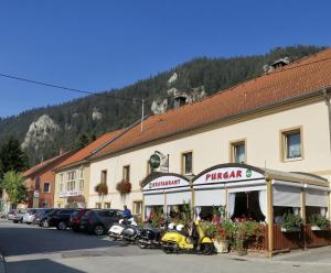 a building with motorcycles parked in front of it at Gästezimmer Purgar in Kammern im Liesingtal