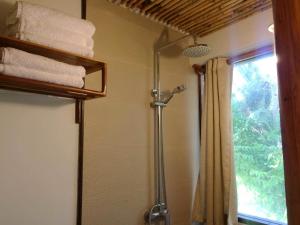 a shower in a bathroom with a shower curtain at Harana Surf Resort in General Luna