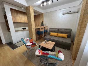 a living room with a couch and a table at Holiday Lux Apartment in Soko Banja
