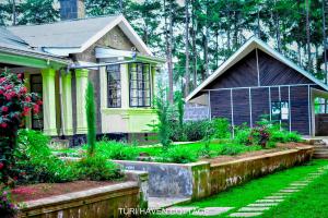 a small house with a garden in front of it at TURI HAVEN COTTAGE in Molo