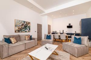 a living room with a couch and a table at The Penthouse Collection by EPIC in Liverpool