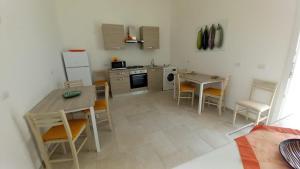 a kitchen with a table and chairs and a refrigerator at B&B Bonomi in Torre Lapillo +58 photos