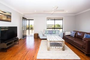 a living room with a couch and a tv at Private Rural Solace at Saje Farm in Cooks Gap in Moolarben