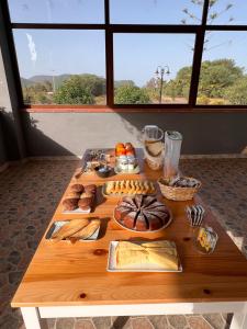 a table with bread and other foods on it at Agriturismo Graziano e Barbara in Porto Conte