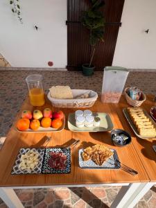 a wooden table topped with different types of food at Agriturismo Graziano e Barbara in Porto Conte