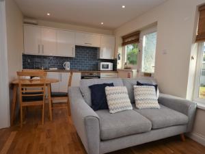 a living room with a couch and a kitchen at 2 Bed in Brixham BX081 in Brixham