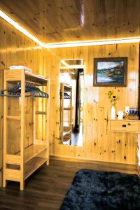 a room with wooden walls and bunk beds at Dớt's Garden Homestay in Da Lat