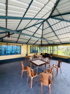 a group of tables and chairs in a large building at Leisure familyvillas in Padinjarathara