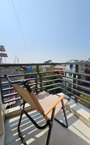 a folding chair sitting on top of a balcony at Frontier Hostel & Tours in Dien Bien Phu