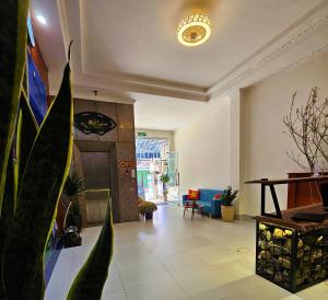 a living room with a couch and a table at Frontier Hostel & Tours in Dien Bien Phu