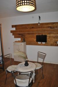 a dining room with a table and chairs and a tv at la morra in Viterbo