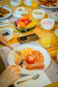 a table with a plate of breakfast food on it at tent Playa de Palma in Playa de Palma