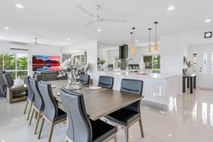 a dining room and kitchen with a table and chairs at Mount Sheridan home with Breath taking views in Cairns