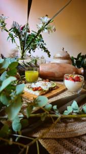 a table topped with two pizzas and a tea pot at BE Jardin Escondido By Coppola in Buenos Aires