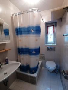 a bathroom with a toilet and a shower curtain at Charmantes Apartment mit Extra-Eingang in Neusäß