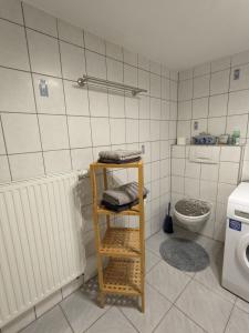 a bathroom with a toilet and a shelf in it at Haus zum Talblick in Solnhofen