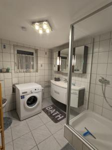 a bathroom with a washing machine and a washer at Haus zum Talblick in Solnhofen