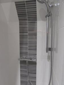 a shower with a glass door in a bathroom at Le Coeur de Domme in Domme