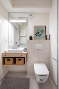 a bathroom with a sink and a toilet and a mirror at MILESTONE Krakow Center Student Living in Krakow