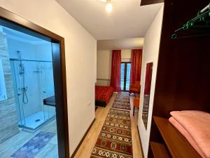 a room with a glass door leading to a bedroom at Pensiunea Rasnoava in Predeal