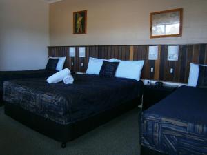 a hotel room with two beds in a room at Kellys Motel Oakey in Oakey