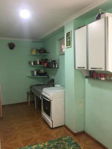 a kitchen with a small refrigerator and a table at Дом тсивадзе in K'obulet'i