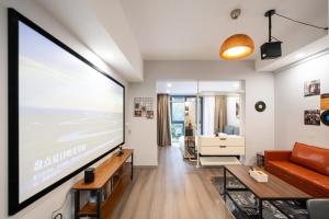 Televízia a/alebo spoločenská miestnosť v ubytovaní Cloud Expo Apartment