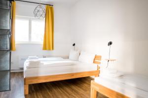 two beds in a room with a window at Three Bedroom plus big kitchen plus SelfCheckIn plus Street Parking in Berlin