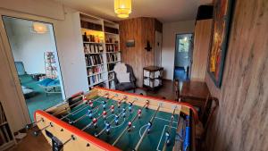 a living room with a pool table in the middle at Chambre d'hôte de Reymure in Vif
