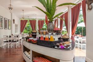 ルアンパバーンにあるHomm Souvannaphoum Luang Prabang, part of Banyan Groupのレストランのテーブルに並べられたビュッフェ形式の食事
