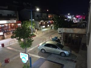 un coche aparcado en un estacionamiento por la noche en BlueSuite en Ayia Napa