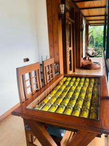 a wooden table in a room with a bench sidx sidx at Cozy Homestay in Ella