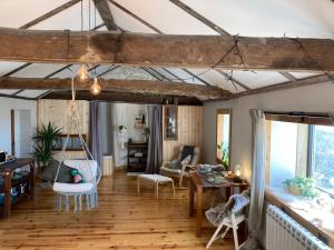 a living room with wood floors and a room with a table at The Loft With a View in Cabeceiras de Basto