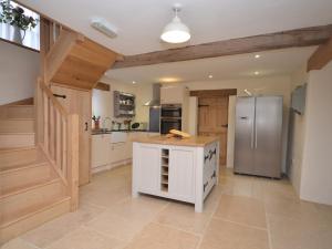 een grote keuken met een koelkast en een aanrecht bij 3 Bed in Tiverton 49356 in Uplowman